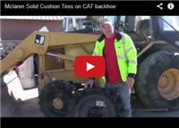 Mclaren Solid Cushion Tires on CAT backhoe